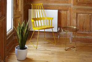 A wooden chair in a wood floor scene